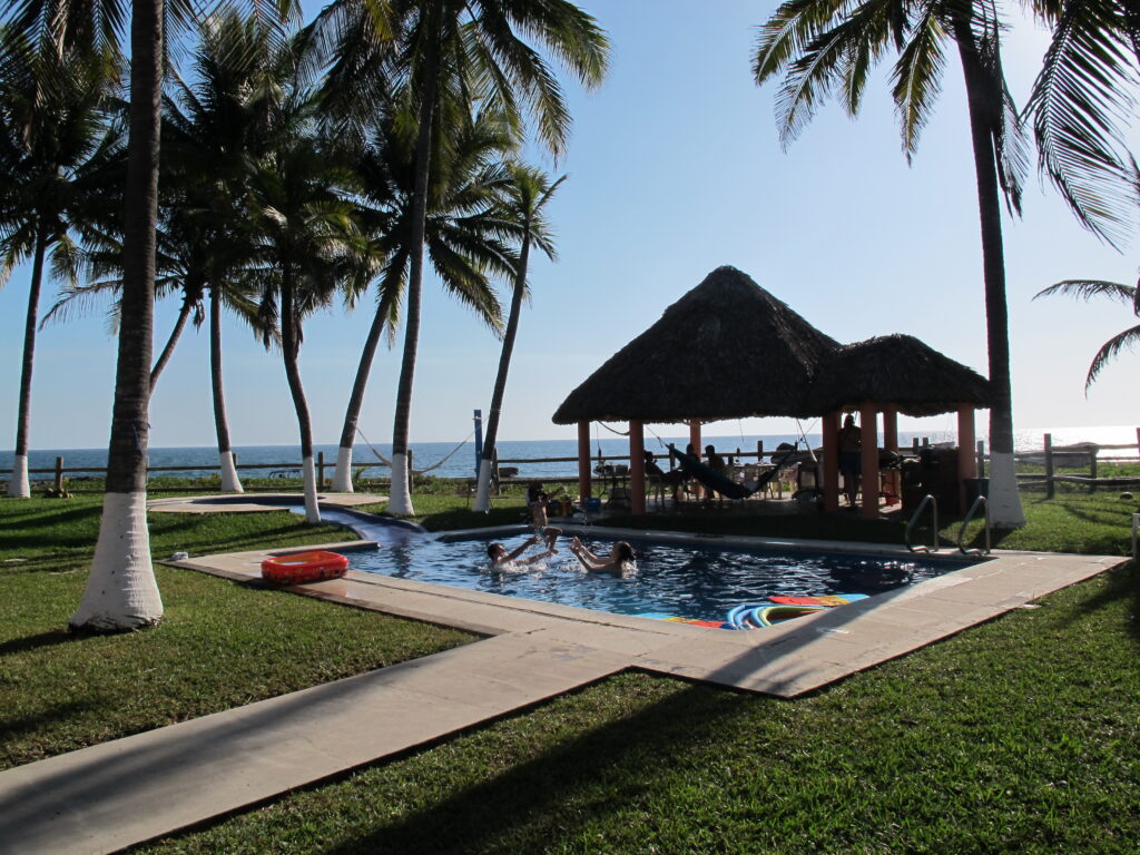 Pool with hut and beach view