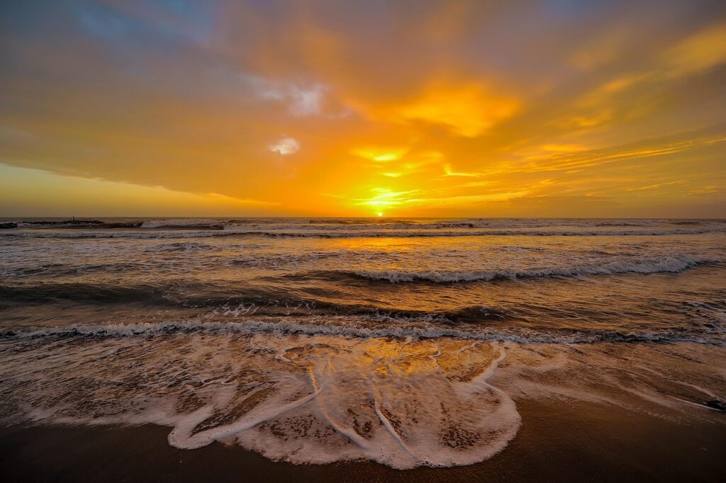 View of the sun setting over the ocean